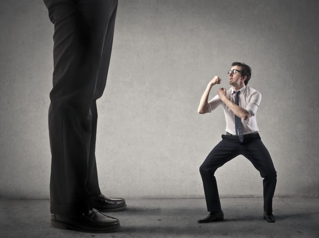 Businessman is fighting against someone bigger